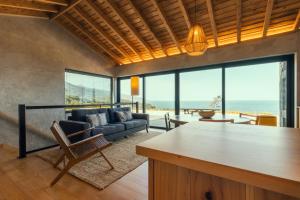 a living room with a view of the ocean at Casa do Alecrim in São Roque do Pico
