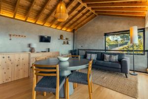 a kitchen and living room with a table and chairs at Casa do Alecrim in São Roque do Pico +37 photos