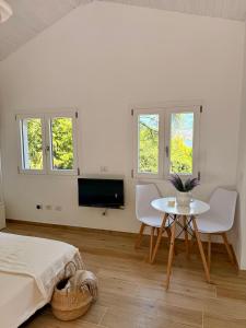a bedroom with a bed and a table and a tv at Casetta a Lago in Onno