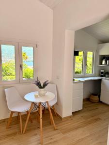 a kitchen and dining room with a table and chairs at Casetta a Lago in Onno