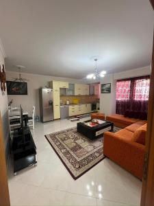 a living room with a couch and a table at SunBeach Apartament in Golem