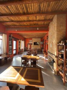 a large room with wooden tables and chairs at Hotel Refugio Del Sol in La Quiaca