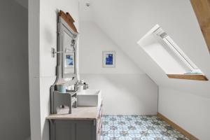 a bathroom with a sink and a mirror at The Purple Courtyard in Beaune +33 photos