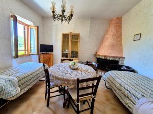 a living room with a table and chairs and a fireplace at La Casa in Piazza in Toffia +67 photos