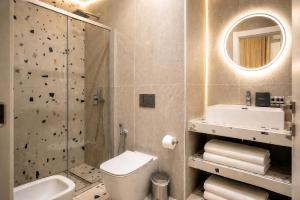 a bathroom with a toilet sink and a shower at Museo Suite in Naples +37 photos