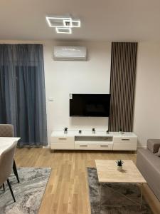 a living room with a large flat screen tv at Sabac City Apartman Centar S2 in Šabac +4 photos