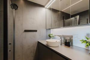 a bathroom with a sink and a shower at Premium Studio mit Balkon - Pfarrkirchen in Pfarrkirchen +7 photos