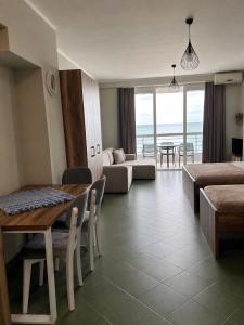 a living room with a table and a couch at Eri Apartments 4 in Shëngjin