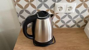 a black and silver kettle sitting on a counter at tARTu Stays 5-3 Spacious Apartment Tartu Old Town in Tartu