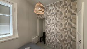 a hallway with a wall with a patterned wall at tARTu Stays 5-3 Spacious Apartment Tartu Old Town in Tartu +35 photos