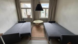 a waiting room with two beds and a table at tARTu Stays 5-3 Spacious Apartment Tartu Old Town in Tartu