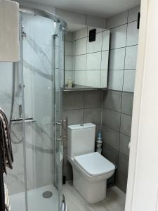 a bathroom with a toilet and a glass shower at Jayslin in Felpham +15 photos