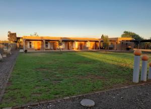 a building with a large yard in front of it at Die Skuur Douglas in Douglas