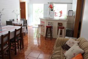 eine Küche und ein Wohnzimmer mit einem Sofa und einem Tisch in der Unterkunft Kantinho da Serra in Nova Petrópolis