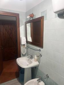 a bathroom with a sink and a mirror at Agriturismo Macchiapiede in Sala Consilina