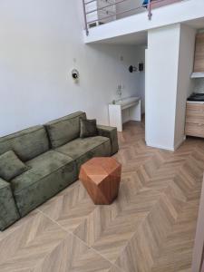 a living room with a couch and a wooden floor at Gonik NN Apartmani in Veliko Gradište