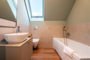 a bathroom with a sink and a bath tub at Domki Poleskie Stodoły in Stare Załucze +48 photos