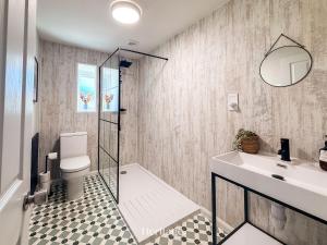 a bathroom with a shower and a sink and a toilet at Nether Clashnoir, Glenlivet in Knockandhu