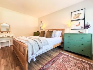 a bedroom with a bed with a blue dresser and a green drawer at Nether Clashnoir, Glenlivet in Knockandhu