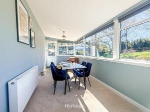a dining room with a table and chairs and windows at Nether Clashnoir, Glenlivet in Knockandhu +16 photos