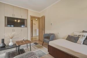 a bedroom with a bed and a living room at Metsovo Fireplace Retreat 2 in Metsovo