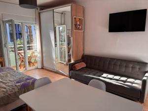 a living room with a couch and a table at Seaview Apartment Pinea Golem in Golem