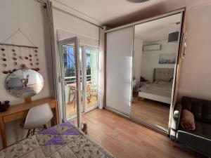 a room with a mirror and a bedroom with a bed at Seaview Apartment Pinea Golem in Golem