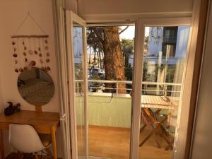 a sliding glass door leading to a balcony with a table at Seaview Apartment Pinea Golem in Golem