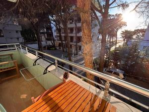 a wooden bench sitting on top of a balcony at Seaview Apartment Pinea Golem in Golem
