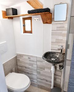 a bathroom with a sink and a toilet at Cocon-ardechesauvage in Pont-de-Labeaume