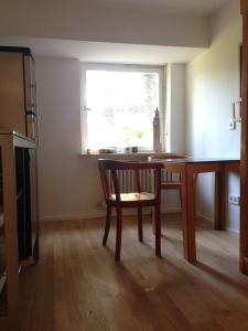a room with a table and a chair and a window at Apartment Ammersee in Dießen am Ammersee