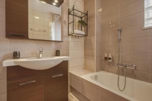 a bathroom with a sink and a bath tub at Metsovo Fireplace Retreat 2 in Metsovo +52 photos