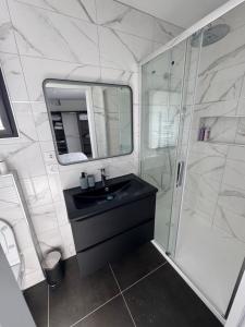 a bathroom with a black sink and a shower at Maison proximité de la plage in Plouzané +32 photos
