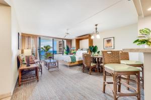 a living room with a bed and a dining room at Oceanfront Kahana Condo Ocean View, Beachfront, Pool & Sleeps 4, Walkable Area in Lahaina +21 photos