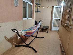 a hammock sitting in the corner of a room at Casa Susan's in Águilas