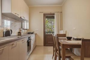 a kitchen with a table and a dining room at Metsovo Fireplace Retreat 2 in Metsovo