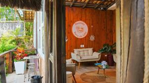 a living room with a couch and a chair at Pousada Barra do Sahy in Barra do Sahy
