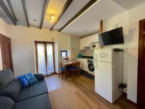 a living room with a couch and a refrigerator at La Atalaya in Laredo