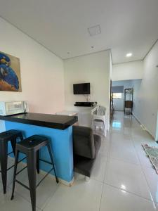 a living room with a blue table and chairs at Hotel Camping R Formoso in Bonito