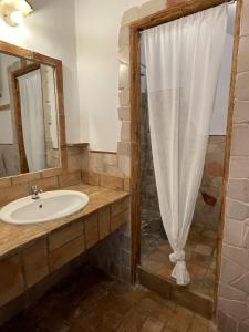 a bathroom with a sink and a shower at Casa Collina - Isola in Pisticci +32 photos