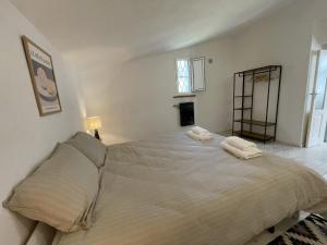 a bedroom with a large bed with two towels on it at Casa Collina - Isola in Pisticci