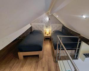 a room with two beds in a attic at B&B De Schorre in Boom