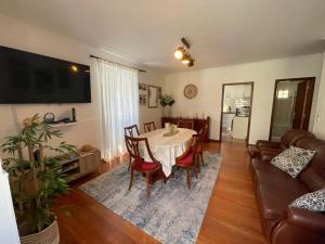 a living room with a table and a couch at Rdj B in Porto Moniz