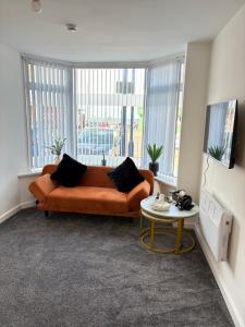 a living room with a couch and a table at Seaside Apartments Redcar in Redcar
