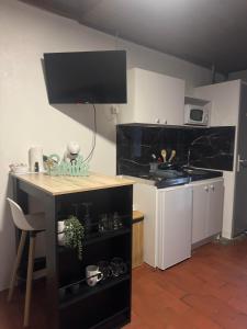 a kitchen with a table and a counter with a stove at studio gien in Gien