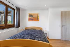a bedroom with a bed and a window at Ferienwohnung am Brändbach in Bräunlingen