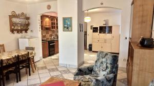a kitchen and dining room with a table and a chair at Apartmán Andels I in Rakovník