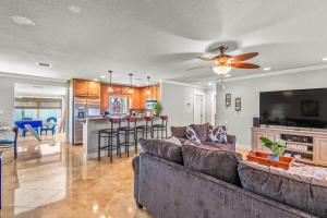 a living room with a couch and a kitchen at Clearwater Calling in Clearwater Beach