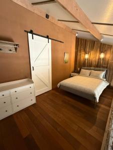a bedroom with a bed and a sliding door at 't Woldhoesie in Diever
