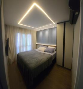 a bedroom with a large bed with a light on it at Vg Sun Cumbuco Beach House in Caucaia +33 photos